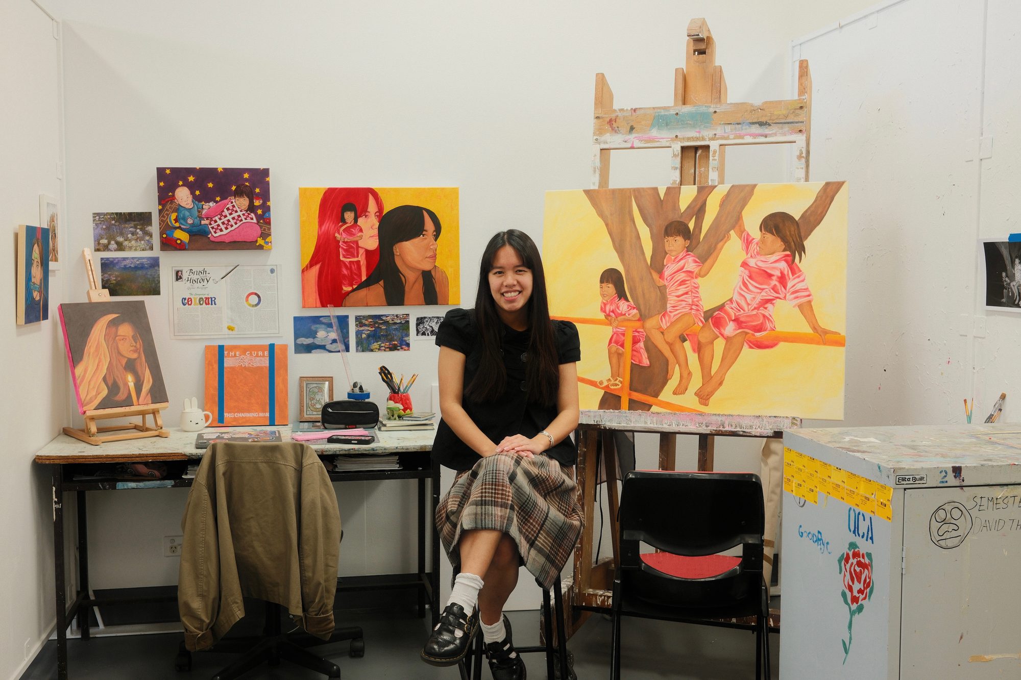 Bree Fraser in her studio, surrounded by her paintings